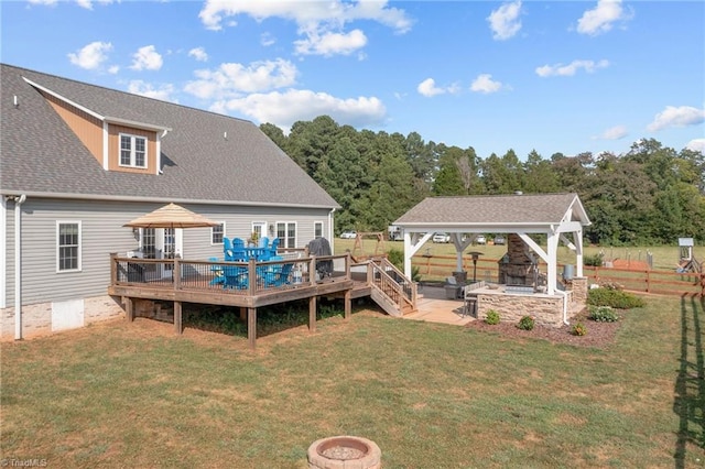 back of house featuring a lawn, a gazebo, a deck, and a patio