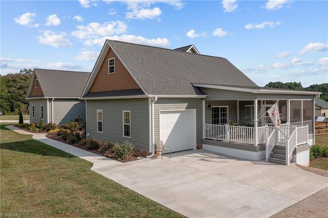 view of front of property with a front lawn, covered porch, and a garage