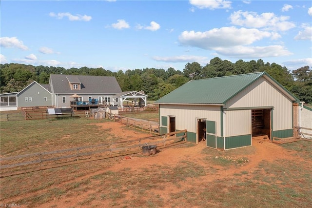 rear view of property featuring an outbuilding