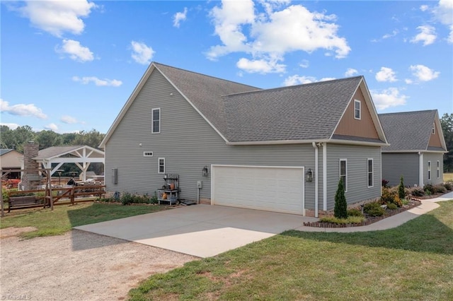 view of side of property with a lawn and a garage