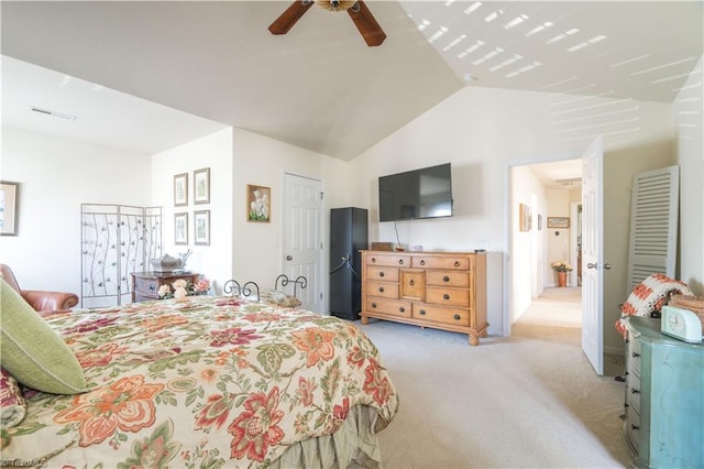 bedroom featuring light carpet, lofted ceiling, and ceiling fan