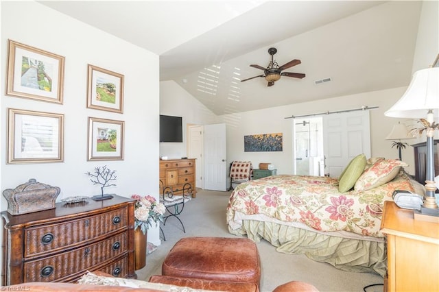 carpeted bedroom featuring ceiling fan, a barn door, and vaulted ceiling