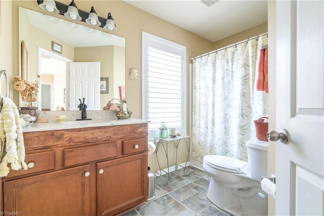 bathroom with toilet and vanity