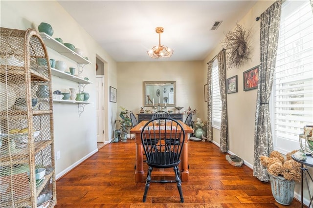 dining space featuring dark hardwood / wood-style flooring