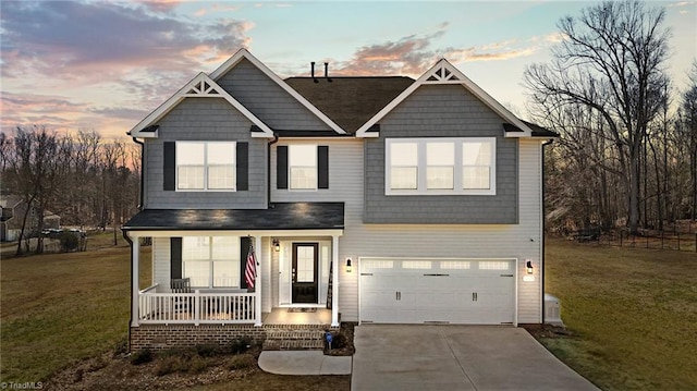 view of front of property with covered porch, concrete driveway, an attached garage, and a front yard