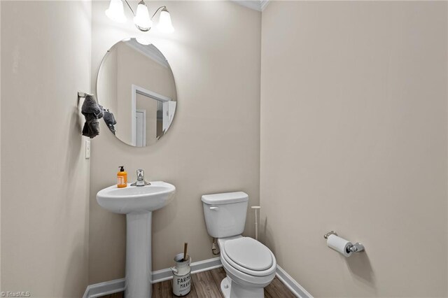 1318 Reading Ct, Burlington, NC 27217 - half bathroom featuring a sink, wood finished floors, toilet, and baseboards
