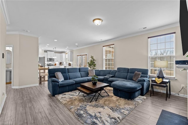 1318 Reading Ct, Burlington, NC 27217 - living area with ornamental molding, light wood finished floors, recessed lighting, and baseboards