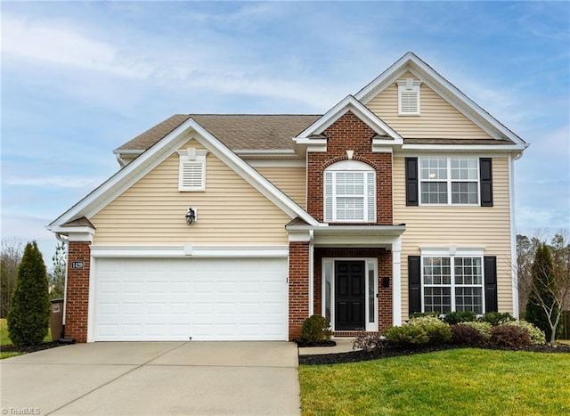 traditional home featuring brick siding, concrete driveway, roof with shingles, an attached garage, and a front yard