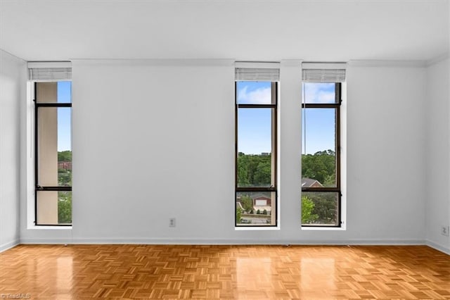 1101 N Elm St Unit 902, Greensboro, NC 27401 - empty room featuring baseboards, plenty of natural light, and ornamental molding
