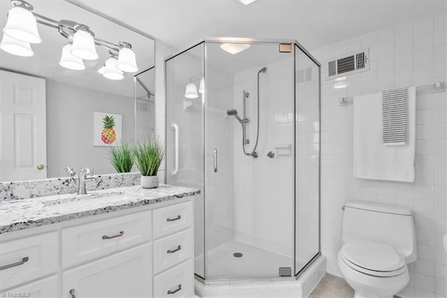 1101 N Elm St Unit 902, Greensboro, NC 27401 - bathroom featuring a stall shower, vanity, and toilet