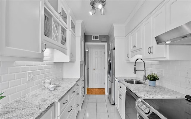 1101 N Elm St Unit 902, Greensboro, NC 27401 - kitchen with a sink, stainless steel appliances, white cabinets, backsplash, and crown molding