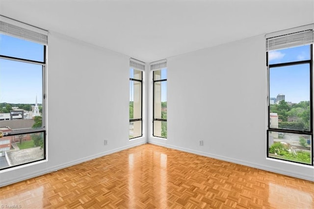 1101 N Elm St Unit 902, Greensboro, NC 27401 - spare room featuring healthy amount of natural light, baseboards, and floor to ceiling windows