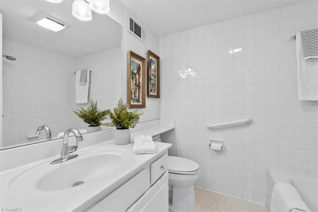 1101 N Elm St Unit 902, Greensboro, NC 27401 - bathroom featuring tile walls, vanity, toilet, and tile patterned floors