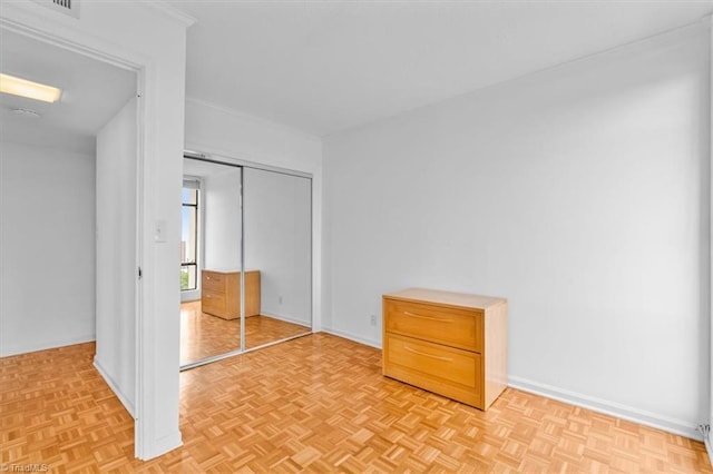1101 N Elm St Unit 902, Greensboro, NC 27401 - unfurnished bedroom with a closet, baseboards, and crown molding