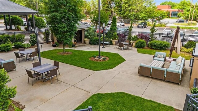 1101 N Elm St Unit 902, Greensboro, NC 27401 - surrounding community with fence, a patio area, and outdoor dining space