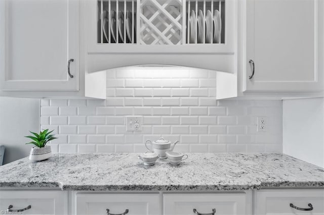 1101 N Elm St Unit 902, Greensboro, NC 27401 - detailed view of white cabinets, decorative backsplash, and light stone counters