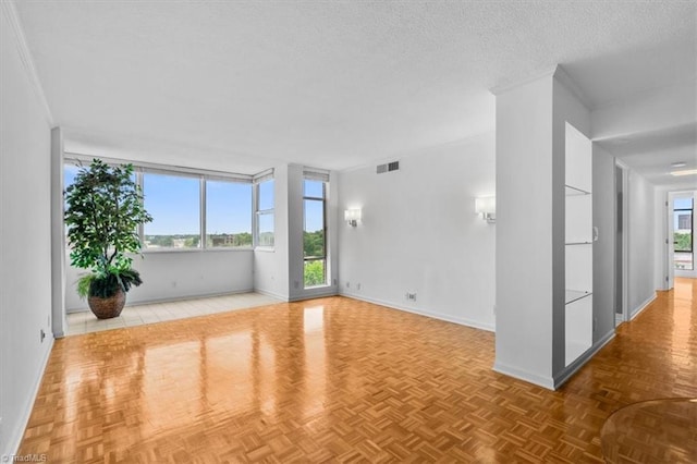 1101 N Elm St Unit 902, Greensboro, NC 27401 - spare room featuring healthy amount of natural light, baseboards, and a textured ceiling