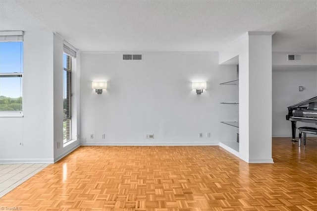 1101 N Elm St Unit 902, Greensboro, NC 27401 - unfurnished living room featuring a textured ceiling and baseboards