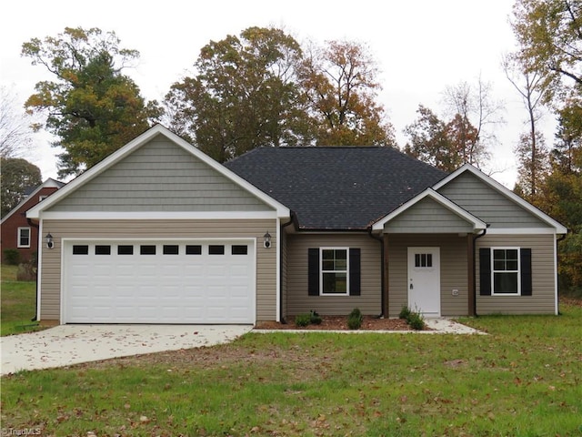 view of front of property with a garage and a front yard