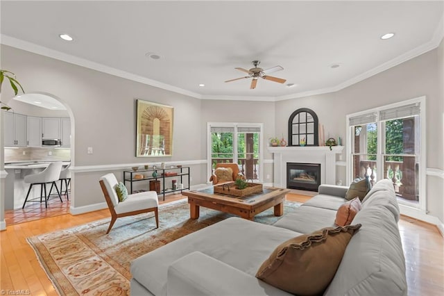 2020 La Dora Dr, High Point, NC 27265 - living area with ceiling fan, recessed lighting, light wood-type flooring, a glass covered fireplace, and crown molding