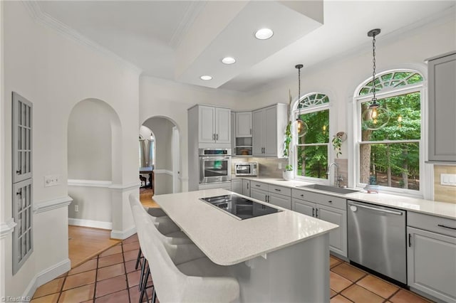 2020 La Dora Dr, High Point, NC 27265 - kitchen featuring stainless steel appliances, ornamental molding, arched walkways, decorative backsplash, and a center island