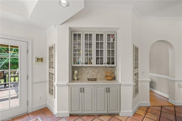 2020 La Dora Dr, High Point, NC 27265 - bar with light tile patterned flooring, crown molding, tasteful backsplash, and recessed lighting