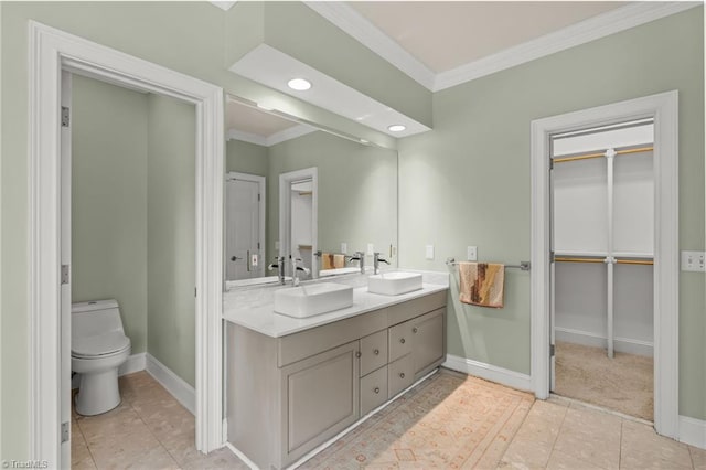 2020 La Dora Dr, High Point, NC 27265 - bathroom with crown molding, double vanity, tile patterned floors, a walk in closet, and recessed lighting