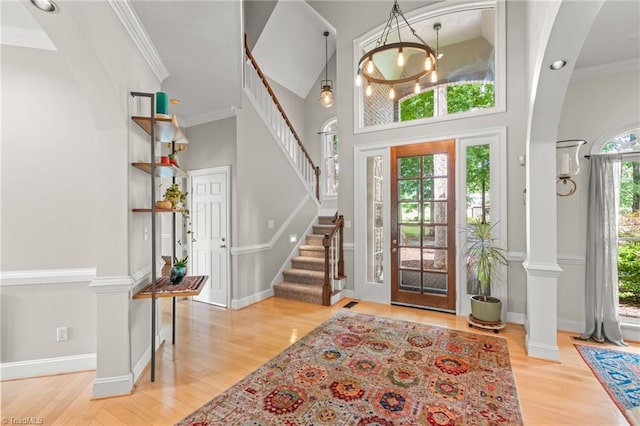2020 La Dora Dr, High Point, NC 27265 - foyer with arched walkways, wood finished floors, stairs, ornamental molding, and a towering ceiling