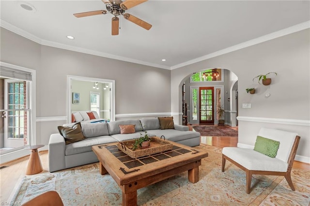 2020 La Dora Dr, High Point, NC 27265 - living area featuring arched walkways, healthy amount of natural light, light wood finished floors, ceiling fan, and crown molding
