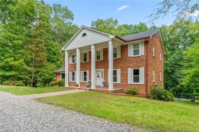 greek revival inspired property with a front lawn