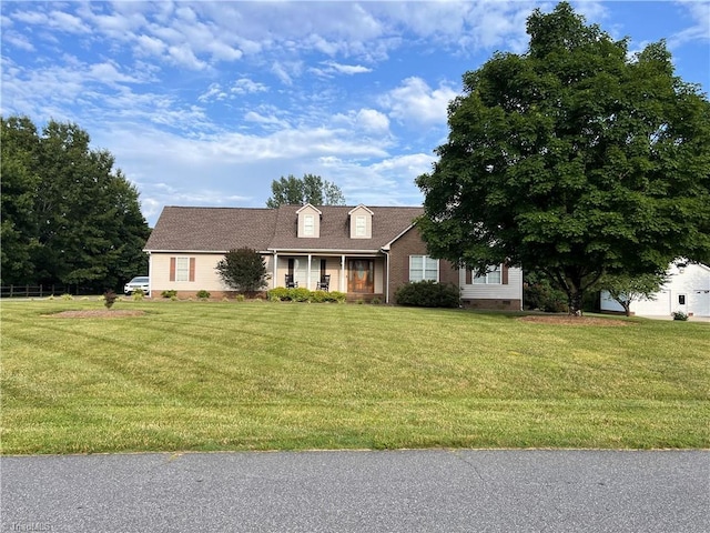 new england style home featuring a front lawn