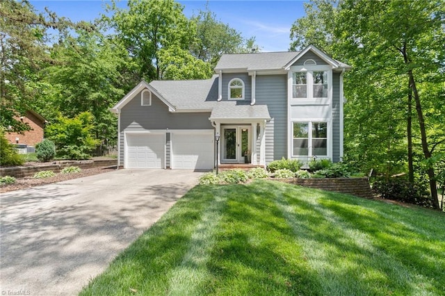 view of front of house with driveway, an attached garage, a front lawn, french doors, and roof with shingles