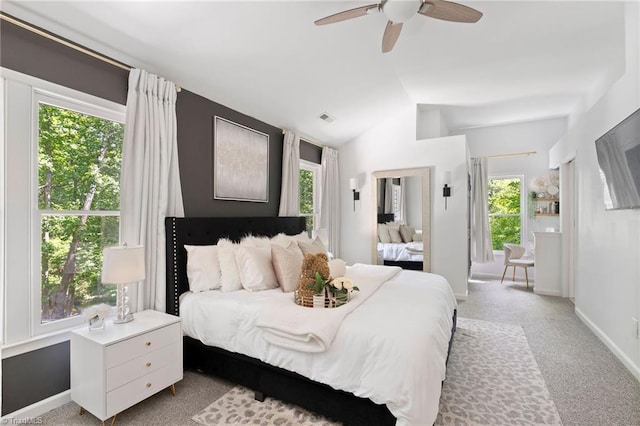 carpeted bedroom with vaulted ceiling, baseboards, and a ceiling fan