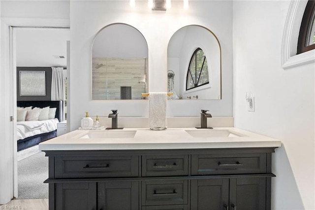 full bath with double vanity, ensuite bath, and a shower