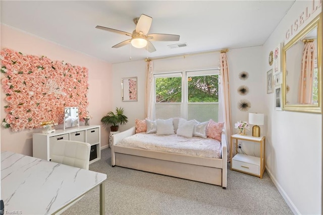 carpeted bedroom featuring ceiling fan and baseboards
