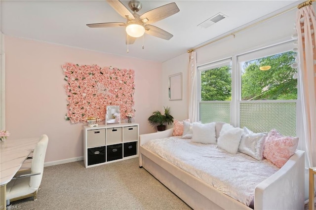 carpeted bedroom with a ceiling fan and baseboards