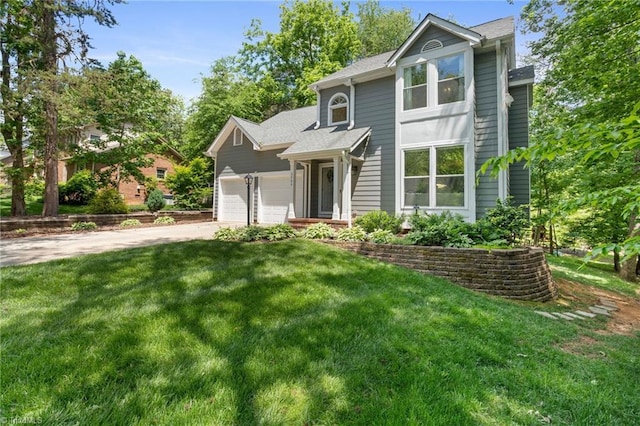 traditional-style home featuring concrete driveway, an attached garage, a front yard, and roof with shingles