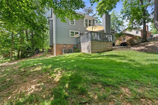 rear view of house featuring a chimney, a lawn, and cooling unit