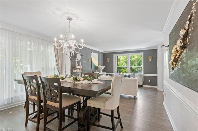 dining area with a chandelier, crown molding, dark wood-style floors, and baseboards