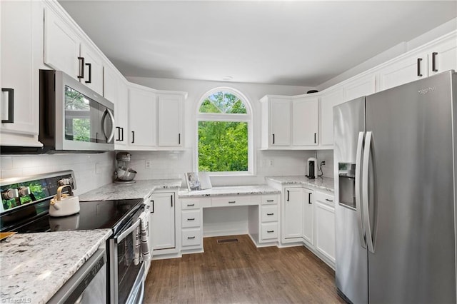kitchen featuring appliances with stainless steel finishes, dark wood-style flooring, backsplash, and white cabinetry