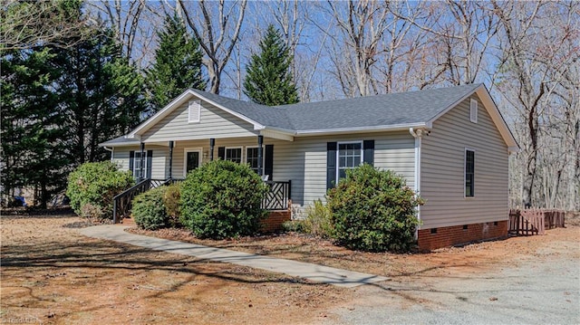 view of front of property with a shingled roof, covered porch, and crawl space