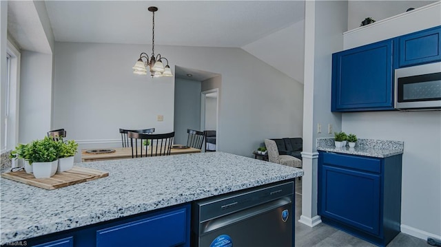 kitchen with stainless steel microwave, blue cabinets, and vaulted ceiling