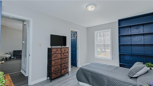 bedroom featuring baseboards and wood finished floors