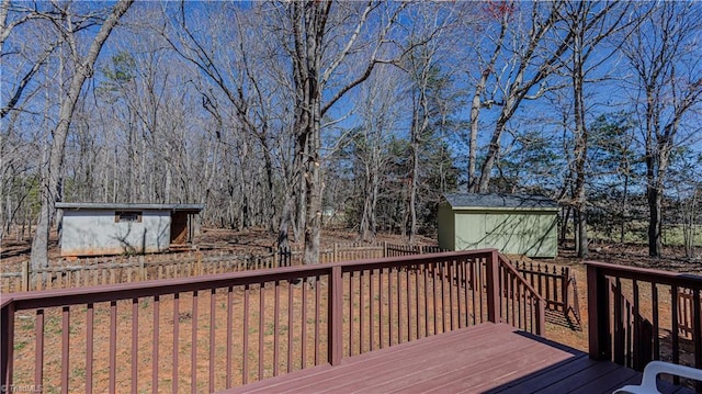 wooden deck with a storage unit and an outdoor structure