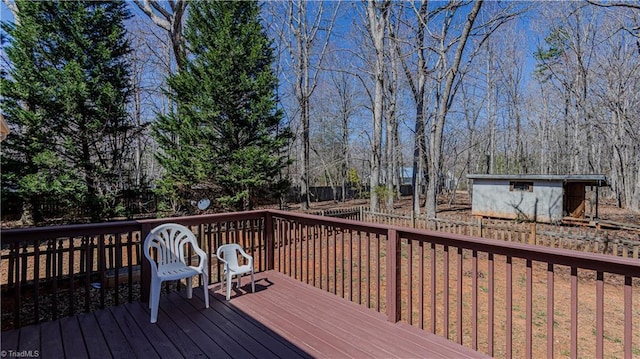 wooden deck with an outdoor structure and a storage unit