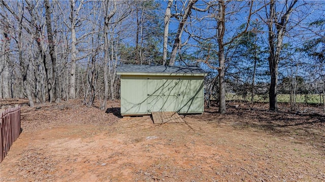 view of shed with fence