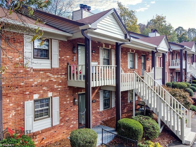 201 Olde Vineyard Ct, Winston-Salem, NC 27104 - multi unit property featuring a chimney, brick siding, a porch, and stairway