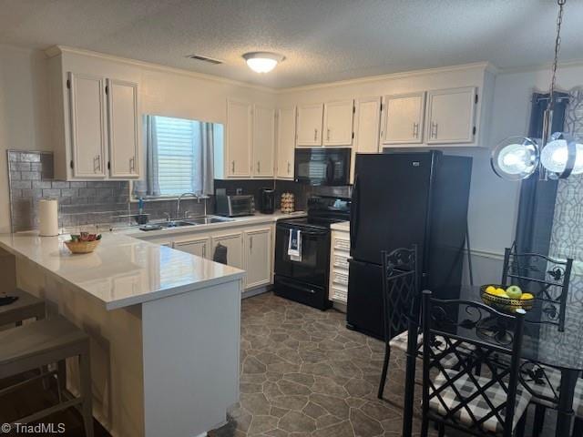 201 Olde Vineyard Ct, Winston-Salem, NC 27104 - kitchen with black appliances, a peninsula, white cabinetry, tasteful backsplash, and ornamental molding