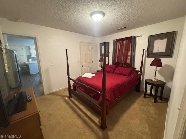 201 Olde Vineyard Ct, Winston-Salem, NC 27104 - carpeted bedroom with a textured ceiling and baseboards