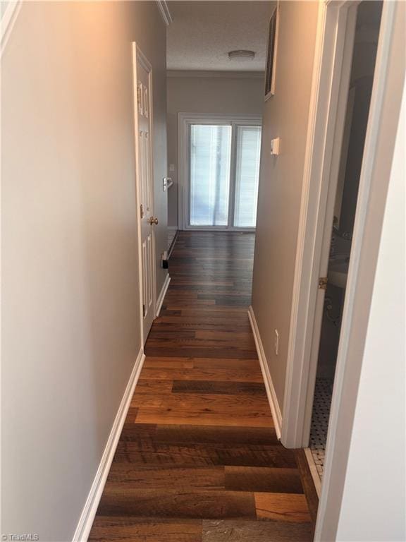 hall with ornamental molding and dark hardwood / wood-style floors